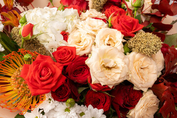 Autumn bouquet of red and white roses, hydrangeas, chrysanthemums as a background.