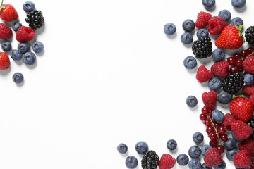 Many different fresh berries on white background, flat lay. Space for text