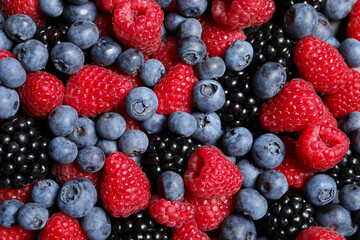 Assortment of fresh ripe berries as background, top view