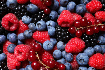 Assortment of fresh ripe berries as background, top view