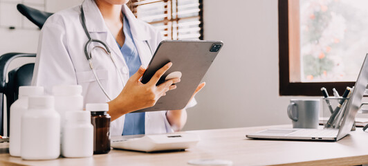 Medical doctor or physician consulting patient's health online using internet mobile digital tablet...
