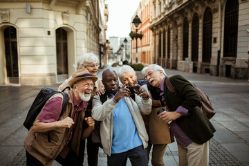 Group of diverse seniors capturing the city with a camera