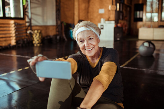 Smiling senior woman taking a selfie at the gym