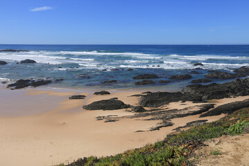 Beautiful Almograve beach with black basalt rocks in Portugal