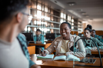 Joyful student engaging in a study session with peers in a high school library