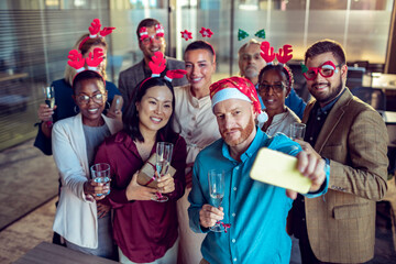 Diverse office team captures a festive selfie moment
