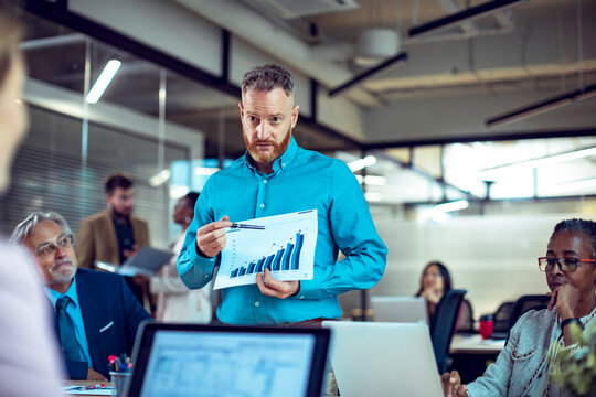 Diverse team collaboratively discussing in a contemporary office setting