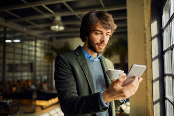 Young businessman using a smartphone in a office