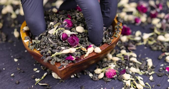 take dry green tea with the addition of jasmine and rose flowers , dry tea leaves with rose and jasmine flowers for making green tea