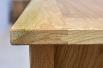 Wooden dinner table surface. Natural wood furniture close view