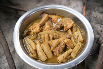 healthy brown fish curry freshly cooked in a village. with banana.