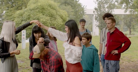 Group game outdoors, communication between friends on the move. Holding hands. Bringing participants closer together and creating a friendly atmosphere.