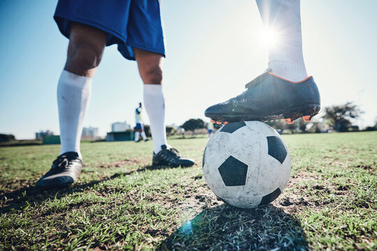 Fototapeta Legs, soccer and ball with players ready for kickoff on a sports field during a competitive game closeup. Football, fitness and teamwork on grass with a team standing in boots to start of a match