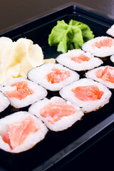 Rolls with salmon in a container close up