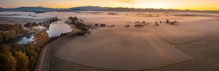 Aerial view of the Skagit River Valley during a beautiful and dramatic autumnal sunrise. The Skagit is renowned for its bald eagles, runs of salmon and steelhead, whitewater and scenic beauty. - 671772072
