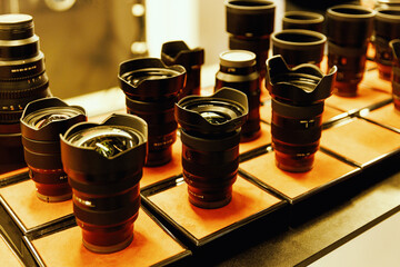 Set of different photographic lenses in a row.