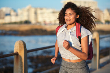 Black woman runner, backpack and sea with smile and summer adventure in city. Gen z and student...