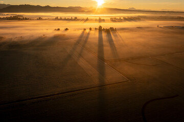 Dramatic sunrise over rural farmland with ground fog adding atmosphere. Morning in the Skagit...