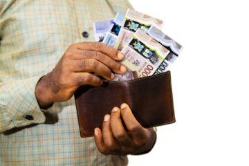 Black person Holding brown wallet
With Jamaican dollar notes, hand removing money out of wallet isolated on white background removing money from wallet