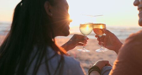 Sunshine, beach and couple with wine, toast and anniversary with happiness, marriage or vacation. Romance, man or woman with alcohol, cheers or relationship with seaside holiday, lens flare or summer