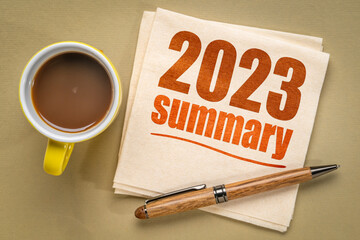 2023 year summary text on a napkin with a cup of coffee, end of year business concept