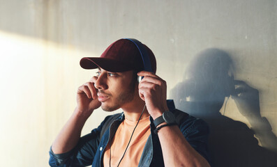 Man, student with headphones and music on campus, future mindset and audio against wall background....