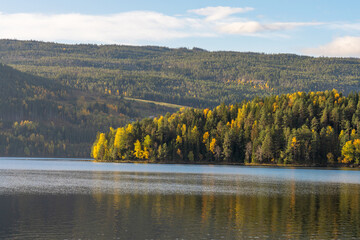 View of the bay over the lake with trees, early autumn colors, Norway
