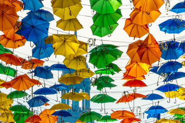 Hamburg, Germany. Colorful umbrellas downtown with the spire of St. Michael's Church (German: St....