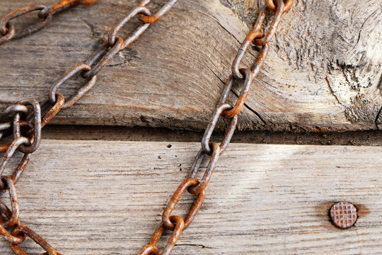 old rusty chain on a wooden background