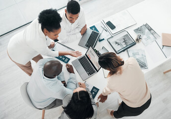 Business people, laptop and meeting in planning above for web design, strategy or brainstorming at...