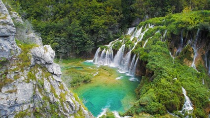 Beautiful waterfalls in summer National Park. Scenic mountain streams flow into a lake with...