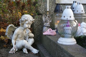 A pink shoe on a child's grave in the cemetery.