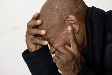 deaf man suffering from deafness and hearing loss on grey black background with people stock image...