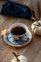 White pumpkins, coffee and autumn leaves on a wooden table. autumn atmosphere. Good morning