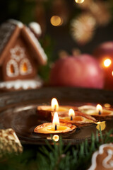 Candles made of nut shells floating in a bowl of water - Christmas custom