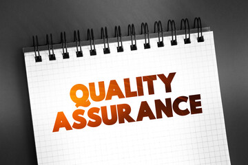QA Quality Assurance - systematic process of determining whether a product or service meets specified requirements, text on notepad, concept background - obrazy, fototapety, plakaty