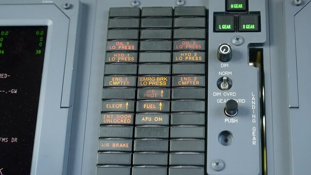 Pedestal close up shot of master warning system of expensive jet Hawker 750. MWS giving visual signals of failure on overhead display panel in flight compartment