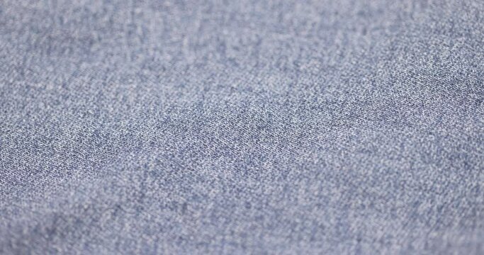 blue denim fabric made of cotton, details of a piece of clothing sewn from blue denim