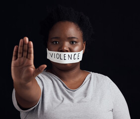 Portrait, hand and a black woman in protest of domestic violence on a dark background. Freedom,...