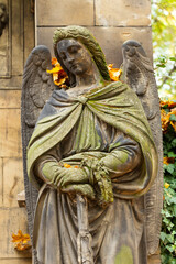 Historic Statue on the autumn mystery old Prague Cemetery, Czech Republic