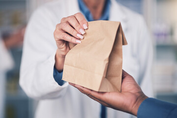 Woman, pharmacist and hands with paper bag for patient, healthcare or medication at the pharmacy. Closeup of female person or medical professional giving pills, drugs or pharmaceuticals to customer - obrazy, fototapety, plakaty