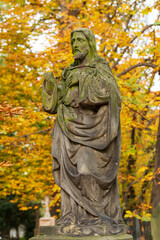 Historic Statue on the autumn mystery old Prague Cemetery, Czech Republic