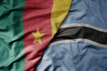big waving national colorful flag of cameroon and national flag of botswana .