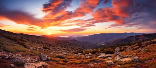The sun going down over the mountain range in Sierra Nevada Spain - obrazy, fototapety, plakaty