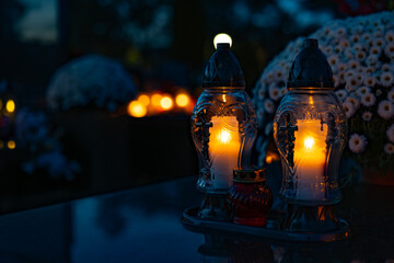 Candle light in the cemetery at night. Selective focus.All saint's day.  Lanterns in the cemetery...