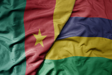 big waving national colorful flag of cameroon and national flag of mauritius .