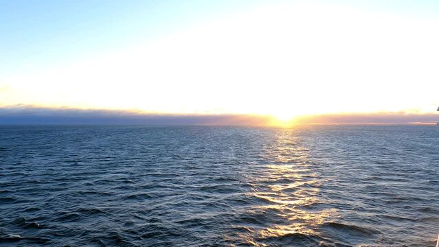 Sailing on a ship in the ocean with a beautiful sunrise view