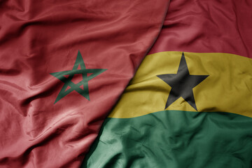big waving national colorful flag of morocco and national flag of ghana .