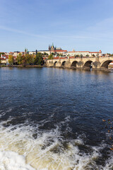 Autumn colorful Prague Lesser Town with gothic Castle above River Vltava in the sunny Day, Czech...