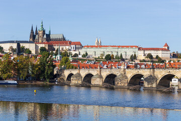 Obraz premium Autumn colorful Prague Lesser Town with gothic Castle above River Vltava in the sunny Day, Czech Republic